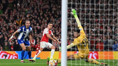 Leandro Trossard scores for Arsenal past Porto goalkeeper Diego Costa to level the tie at 1-1. Getty Images