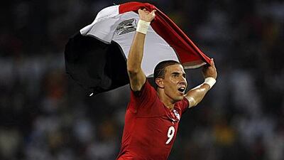 Mohamed Zidan celebrates on the pitch with the Egyptian flag after winning the African Cup of Nations in Angola.