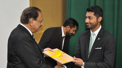 Pakistan president Mamnoon Hussain, left, presents Dubai resident Mobisher Rabbani with his award. Courtesy Pakistan government