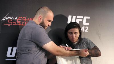 Claudia Gadelha signs an autograph at the UFC fan zone. Yas Island, Abu Dhabi. Chris Whiteoak / The National