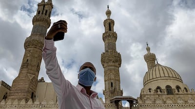 A man wearing a protective face mask takes a selfie photo by his mobile phone after attending the Friday prayers inside Al Azhar mosque. Reuters