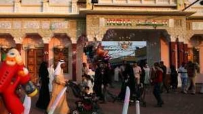 A vendor sells children's toys in front of the India pavilion of Dubailand Global Village.
