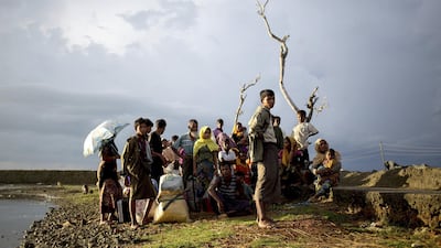 A group of Rohingya refugees who reached the Bangladesh overnight wait at sunrise to be allowed access to an official registration centre. Antolin Avezuela