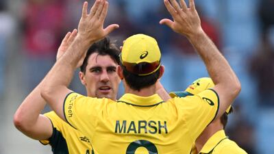 Australia's captain Pat Cummins celebrates with teammate Mitchell Marsh after taking the wicket of Sri Lanka's Kusal Perera. AFP