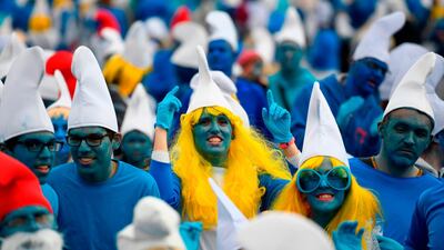 People dressed as Smurfs, a Belgian comic franchise centred on a fictional colony attend a world record gathering of Smurfs in Landerneau, western France. AFP