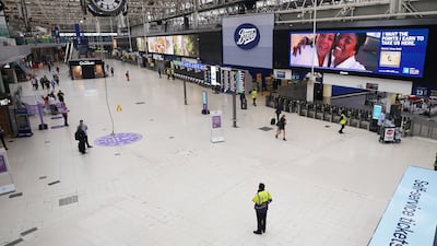 Passengers at a deserted Waterloo East station in London. PA
