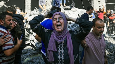 A Palestinian woman looks for victims in the rubble of a building following an Israeli strike in Khan Younis. AFP