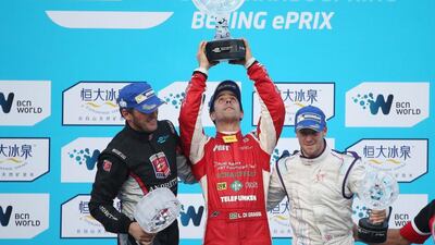 Lucas di Grassi, centre, of Brazil and Audi Sport ABT Formula E team, celebrates winning the Formula E Beijing ePrix on Saturday, the first Formula E race. Frank Montagny, left, finished second and Sam Bird, right, finished third. How Hwee Young / EPA