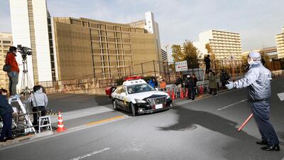 A police car drives away from Tokyo Detention Centre, where former Nissan chairman Carlos Ghosn and another former executive Greg Kelly, are being detained, in Tokyo. AP Photo