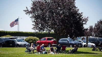 People sit together at Peace Arch Historical State Park in Blaine, Washington. AP