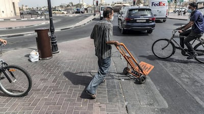 A porter pushes a trolley in Deira on June 22.