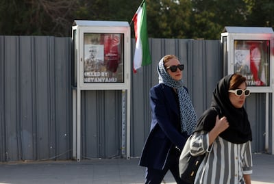 Iranian women in Tehran walk past posters of Mohammad Bagheri who was killed this month. EPA