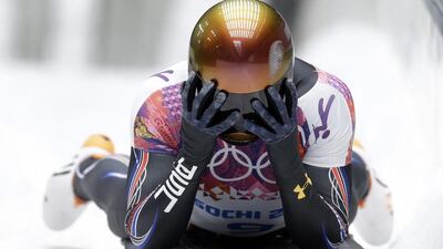 John Daly of the United States puts his head in his hands after a bad final run that dropped him out of medal contention during the men's skeleton competition on Saturday. Natacha Pisarenko / AP