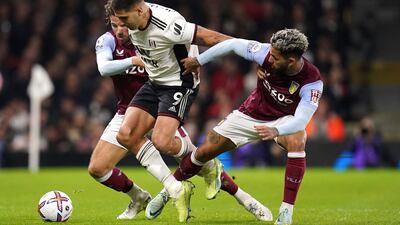 Aston Villa's Douglas Luiz, right, and Fulham's Aleksandar Mitrovic battle for the ball. PA