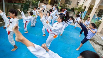 Nguyen Ngoc Hai practises her high kick at the Christina Noble Children's Foundation in Ho Chi Minh City, Vietnam. The story about the foundation's work in the south-east Asian city won The National's Paul Radley the 'Sport for a better world' award in Abu Dhabi on Tuesday night. Ehrin Macksey / The National