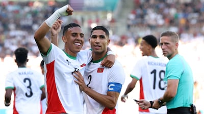 (From L) Morocco's forward #09 Soufiane Rahimi celebrates scoring the opening goal with Morocco's defender #02 Achraf Hakimi in the men's bronze medal football match between Egypt and Morocco during the Paris 2024 Olympic Games at the La Beaujoire Stadium in Nantes on August 8, 2024. (Photo by ALAIN JOCARD / AFP)