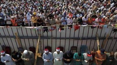 Members of the Muslim Brotherhood and supporters of deposed Egyptian President Mohammed Morsi pray during a funeral for two people killed in recent clashes at Rabaa Adawiya Square, Nasr City, east of Cairo.