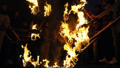 Jammu Kashmir Liberation Front activists hold torches as they shout slogans in Srinagar during a rally against the continuing Indian general elections. JKLF and several other separatist organisations have jointly appealed to the people of Jammu and Kashmir to boycott Indian parliamentary elections. Rouf Bhat / AFP Photo