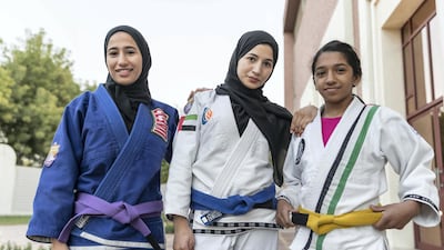 From left: Al Hanaei sisters Maha, 18, Mahra, 16 and Hana, 14, are in action at this weekend's Abu Dhabi Grand Slam at Zayed Sports City. Antonie Robertson / The National