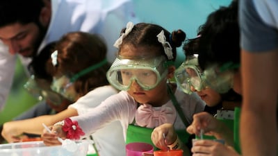 Children take part in an activity during the opening day of the Abu Dhabi Science Festival at Umm Al Emarat Park in Abu Dhabi (Christopher Pike / The National)