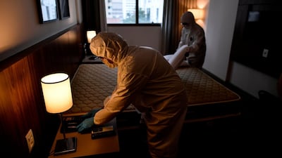 Members of the cleaning staff disinfect a room at a hotel in Belo Horizonte, Brazil, which continues to operate despite the coronavirus pandemic. AFP