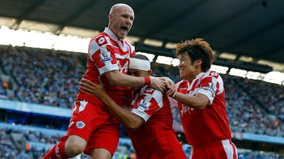 Queens Park Rangers' Bobby Zamora celebrates his goal against Manchester City with teammates Park Ji-Sung and Andrew Johnson. Phil Noble/Reuters