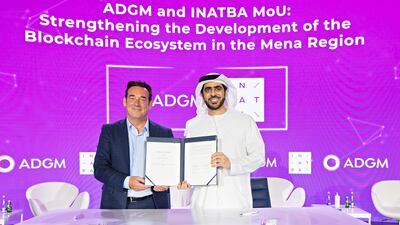 Juma Al Hameli, right, and Marc Taverner at the signing ceremony between ADGM and Inatba. Photo: ADGM