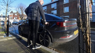 Connected Kerb chief executive Chris Pateman-Jones plugs his electric car into one of the company's on-street chargers in London. Reuters