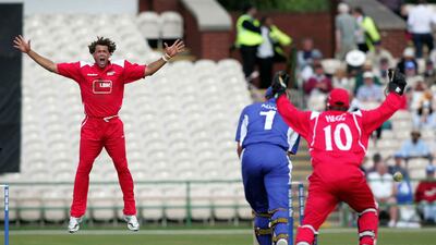 Andrew Symonds celebrates taking the wicket of Sussex's Chris Adams while playing for Lancashire. PA