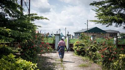 A woman walks out of the Okerenkoko Cottage Hospital site in Okerenkoko. The hospital has been closed due to a lack of funding since the embattled ex-militant leader Government Ekpemupolo has been on the run from the Nigerian Government. Stefan Heunis/AFP