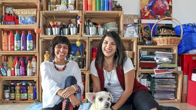 Abu Dhabi, U.A.E., February 2, 2019. Christina (right) and Tanya Awad with their dog Brownie, have brought together hundreds of people since they launched their indie arts and culture initiative, Blank Canvas Community. Victor Besa/The National Section: WK Reporter: Nathalie Farah