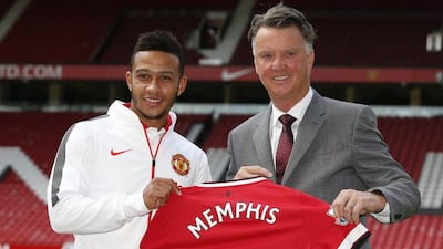 Memphis Depay is presented as a Manchester United player alongside manager Louis van Gaal. Andrew Yates / Reuters