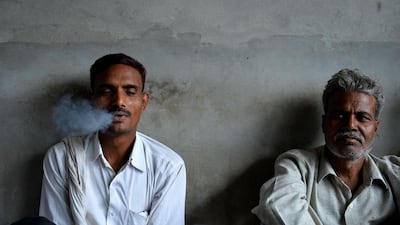 Workers smoke during a break at The New Sarkar Bidi Factory in Kannauj.