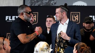 Gareth Bale, right, shakes hands with a fan. AP Photo