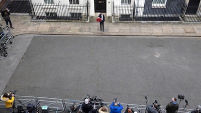 Rishi Sunak holds the budget box up for photographers and cameramen outside 11 Downing Street. Simon Dawson/No 10 Downing Street