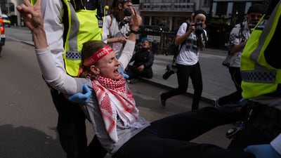 Police remove protesters from outside the Royal Courts of Justice. PA