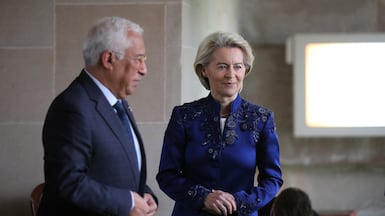 Ursula von der Leyen, right, wears a blue Anamika Khanna bandhgala during a wreath-laying ceremony at Mahatma Gandhi memorial in New Delhi. EPA