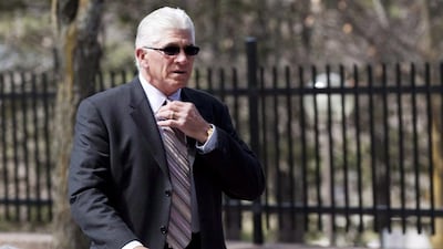 Former Toronto Maple Leafs captain Rick Vaive adjusts his tie as he enters a courthouse in Newmarket, Ontario. Vaive has withdrawn from a class-action lawsuit that claims the NHL has not done enough to protect players from concussions. Michelle Siu / AP Photo