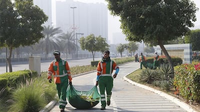Municipality wokers clean up the Corniche where the majority of people gathered to watch the midnight fireworks for New Year’s Eve. Ravindranath K / The National