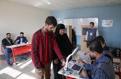 Displaced Iraqis have their IDs checked before voting at a camp in northern Iraq. AFP