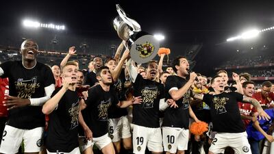 Valencia's players celebrate with the Copa del Rey trophy after beating Barcelona 2-1. EPA