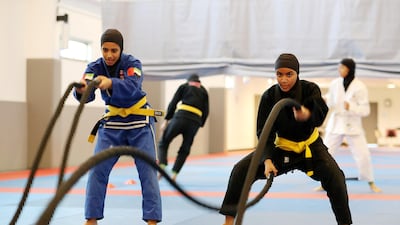 Shamsa Al Amire, in blue, and Shamsa Al Ketbi train at Zayed Sports City in Abu Dhabi. Pawan Singh / The National