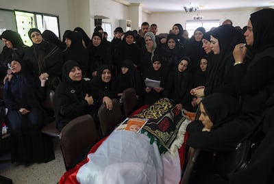 Mourners gather around a coffin during the funeral for members of a family in Wardaniyeh, southern Lebanon. EPA