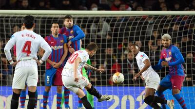 Sevilla midfielder Ivan Rakitic attempts a free kick against Barcelona. AFP
