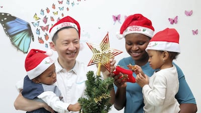 Tuan Phan of SimplyFI.org with his wife Betty Omodamwen and their children Morris, 1, and Alma, 2, at their Abu Dhabi home. Mr Phan limits Christmas gifts to his children to one toy each, under Dh50, and one small present each of Dh100. Chris Whiteoak / The National