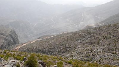 The road under construction, seen from the crest of a ridge about 20 minutes' walk from Defilis. It will travel up Jebel al Jais, the highest peak in the UAE.