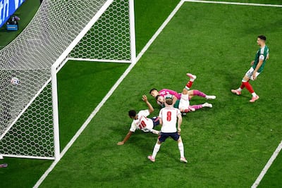 England's Jude Bellingham slides in for his second goal of the match. AFP