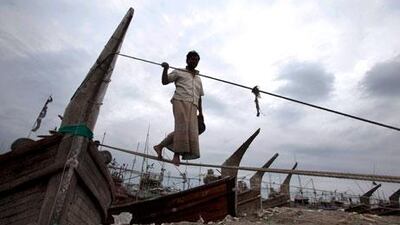 A Bangladeshi fisherman anchors down his boat on the banks of the river Kornofuli in Chittagong in anticipation of Cyclone Mahasen. AM Ahad / AP Photo