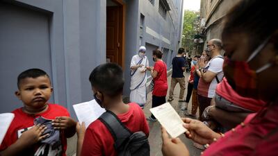 People pray at Mother Teresa's Mother House that is closed on Good Friday during the coronavirus COVID-19 pandemic in Kolkata, eastern India. Good Friday is a religious holiday observed by Christians in commemoration of the crucifixion of Jesus Christ. EPA