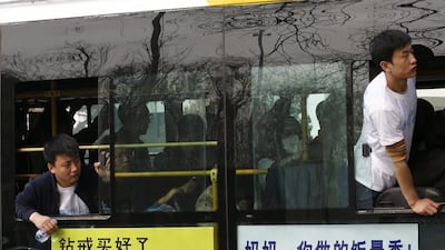Family members of passengers onboard Malaysia Airlines Flight MH370 look out of the windows of a bus before heading to the Malaysian embassy. Kim Kyung-Hoon / Reuters